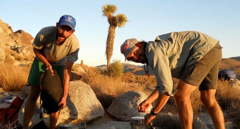 Two people work together to prepare food in Joshua Tree National Park